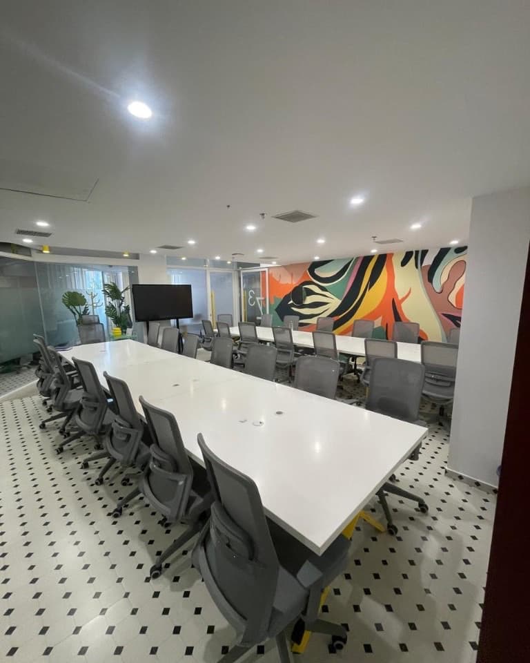 Corrivex training floor with a long briefing table and mural wall at HiLITE Business Park, Kozhikode